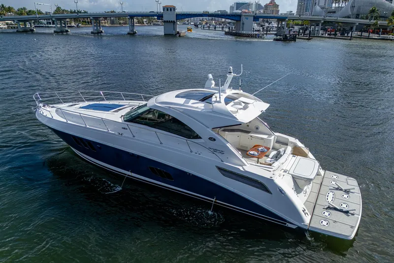 Slide: The Image of 2012 Sea Ray 540 Sundancer yacht cruising in a scenic harbor setting. - 15