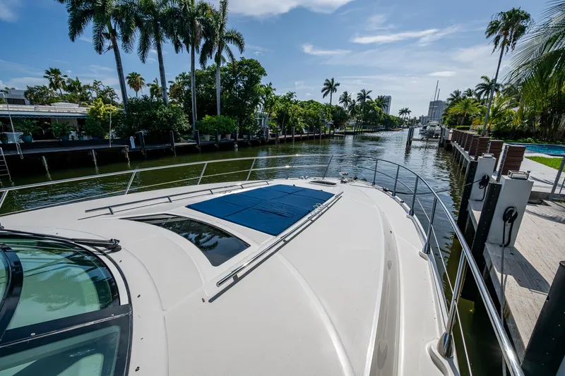 Slide: The Image of 2012 Sea Ray 540 Sundancer cruising on a scenic, palm-lined waterway. - 17