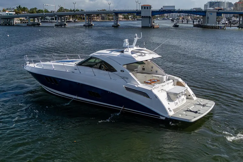 Slide: The Image of 2012 Sea Ray 540 Sundancer yacht cruising near a bridge on a sunny day. - 2