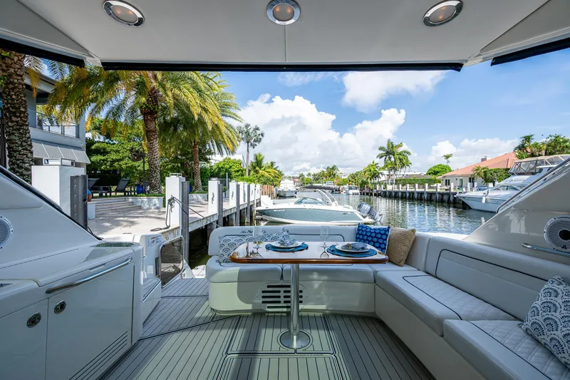 Slide: The Image of Luxurious 2012 Sea Ray 540 Sundancer yacht interior with elegant dining setup and scenic marina view. - 25