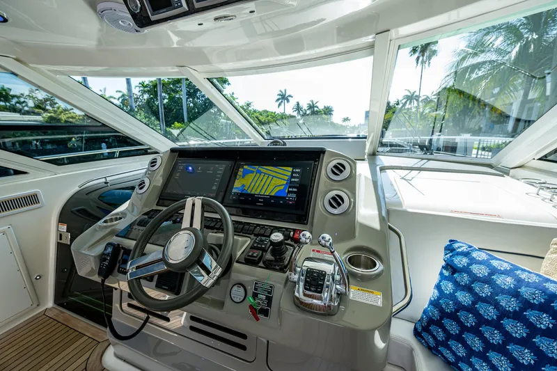 Slide: The Image of 2012 Sea Ray 540 Sundancer helm with modern navigation system and tropical view. - 29