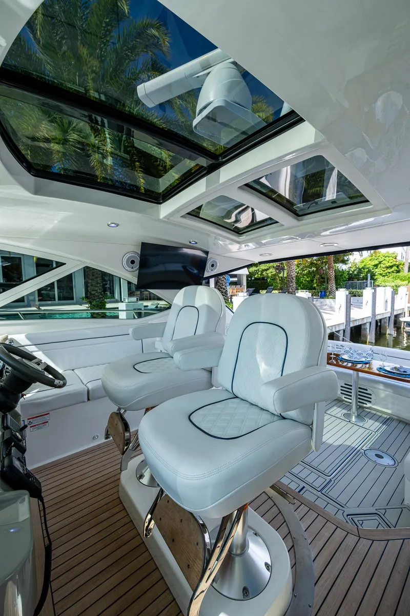 Slide: The Image of 2012 Sea Ray 540 Sundancer cockpit with luxurious seating and panoramic windows. - 32