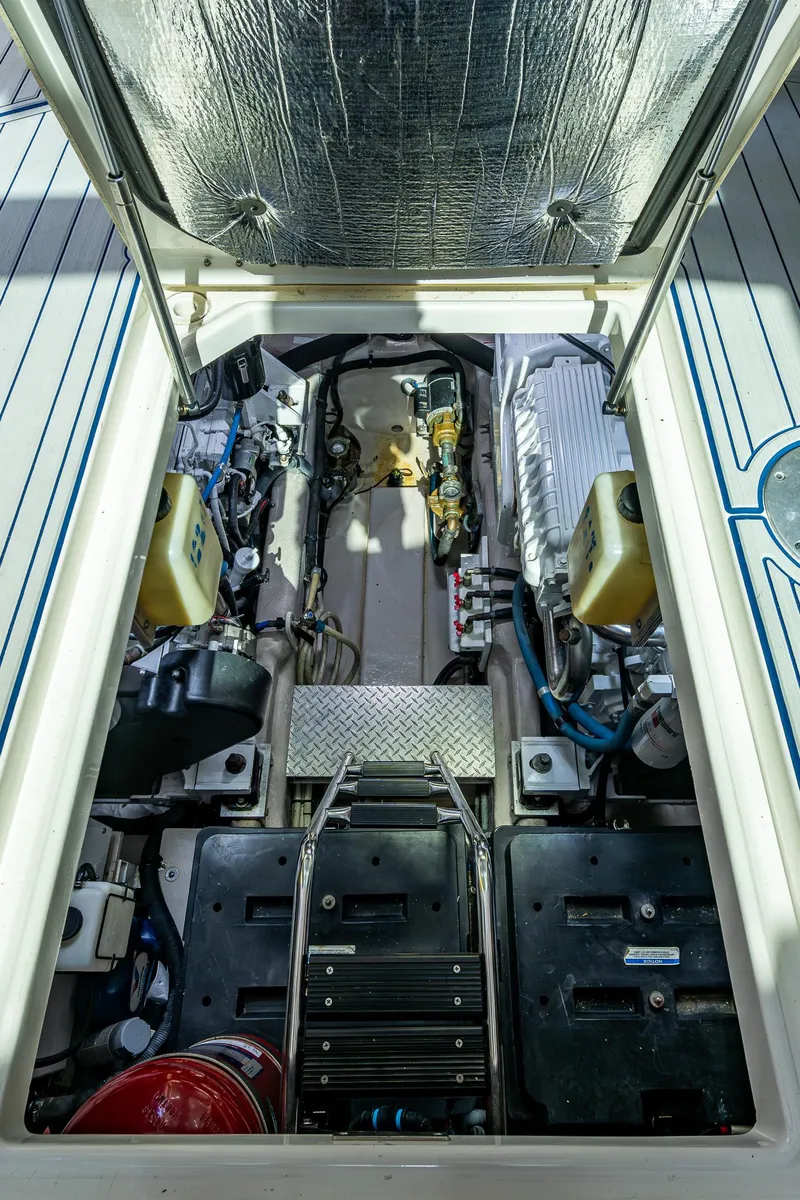 Slide: The Image of Engine compartment of 2012 Sea Ray 540 Sundancer yacht, showcasing mechanical components and layout. - 43