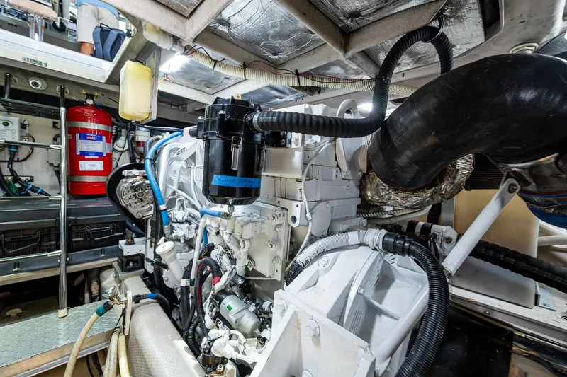 Slide: The Image of Engine room of 2012 Sea Ray 540 Sundancer yacht, showcasing mechanical components and fire extinguisher. - 46