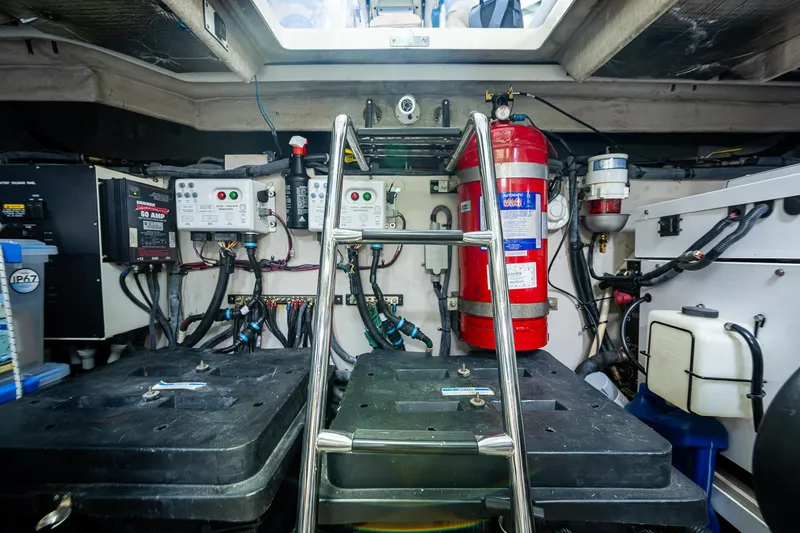 Slide: The Image of Engine room of 2012 Sea Ray 540 Sundancer with equipment and fire extinguisher. - 48