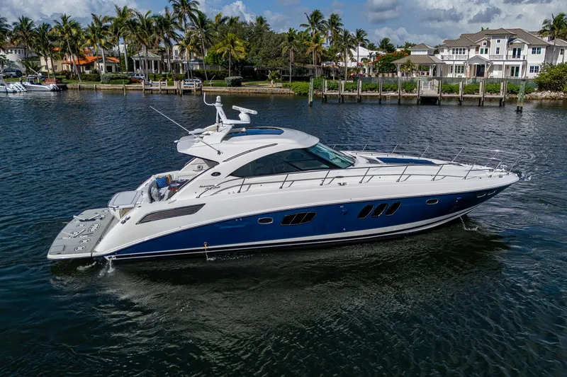 Slide: The Image of 2012 Sea Ray 540 Sundancer yacht cruising on a scenic waterfront with palm trees. - 7