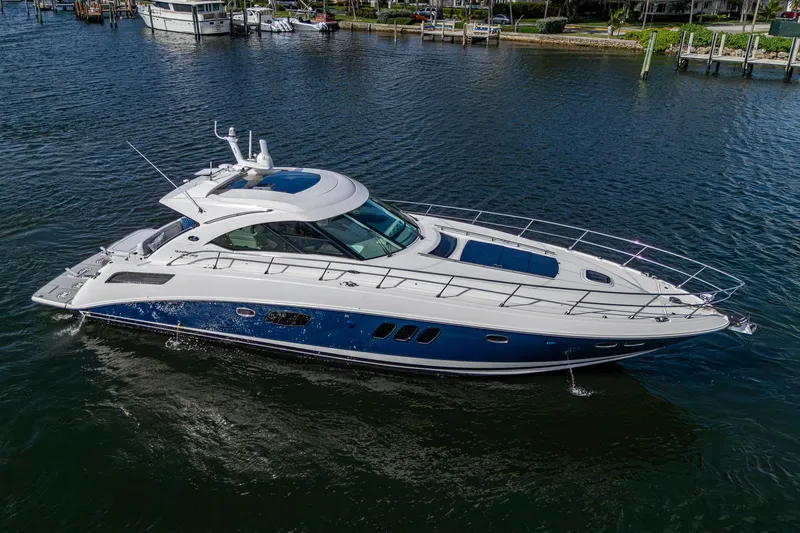 Slide: The Image of 2012 Sea Ray 540 Sundancer yacht cruising on a calm waterway. - 8