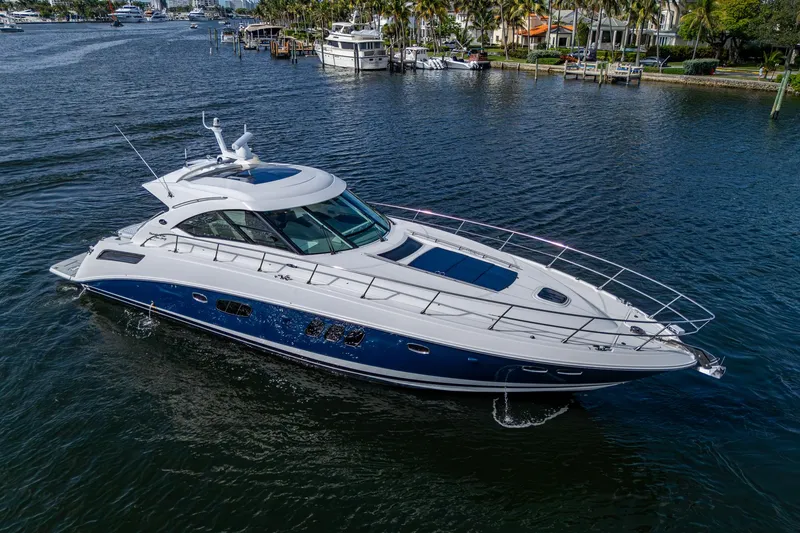 Slide: The Image of 2012 Sea Ray 540 Sundancer yacht cruising on a calm waterway. - 9