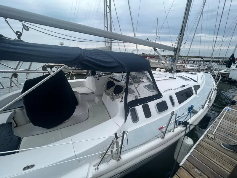 Slide: The Image of Sailboat Hunter 410, 2000 model, docked at marina with overcast sky. - 10