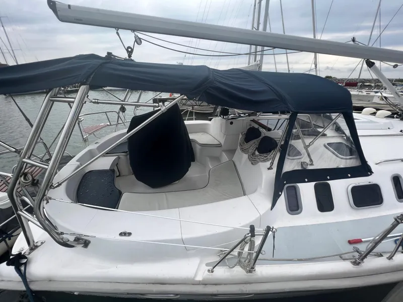 Slide: The Image of Sailboat Hunter 410, 2000 model, docked with blue canopy and spacious cockpit. - 11