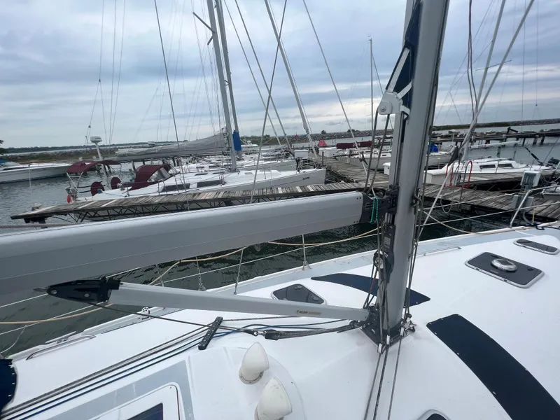 Slide: The Image of Sailboat deck view at marina, Hunter 410, 2000 model, with masts and docked boats. - 13