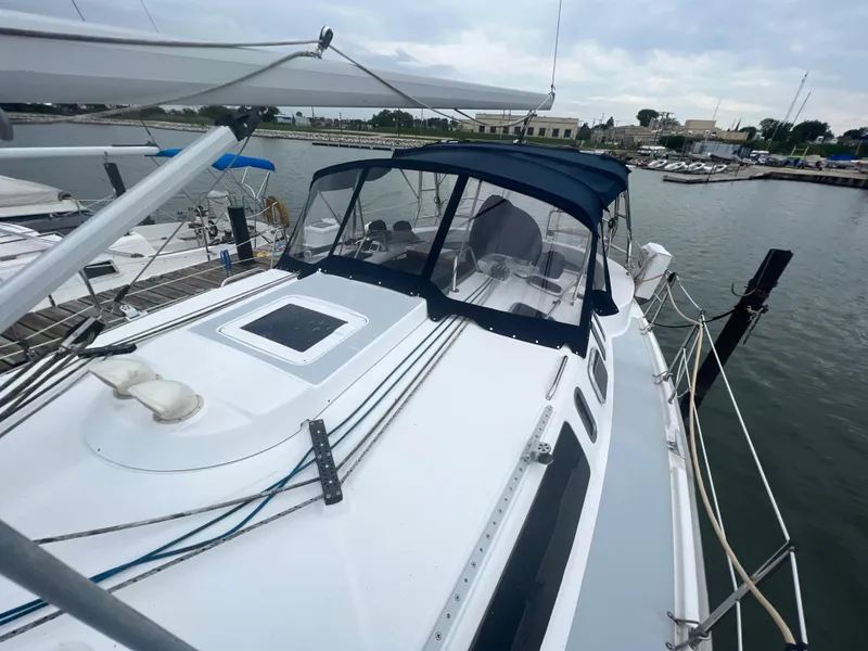 Slide: The Image of Hunter 410 sailboat from 2000 docked at a marina, featuring a sleek white deck. - 19