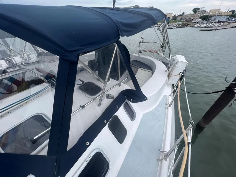 Slide: The Image of Sailboat Hunter 410, 2000 model, docked with blue canopy and visible deck details. - 20