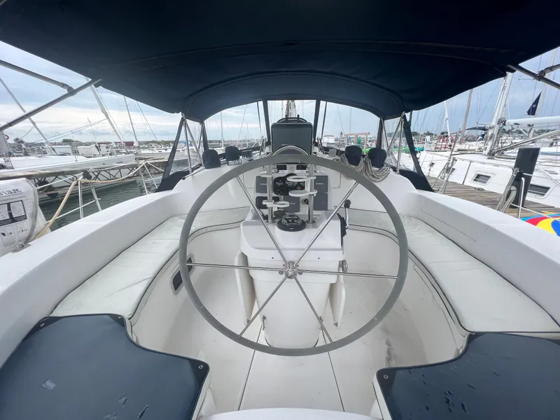 Slide: The Image of Cockpit view of a 2000 Hunter 410 sailboat in a marina setting. - 22