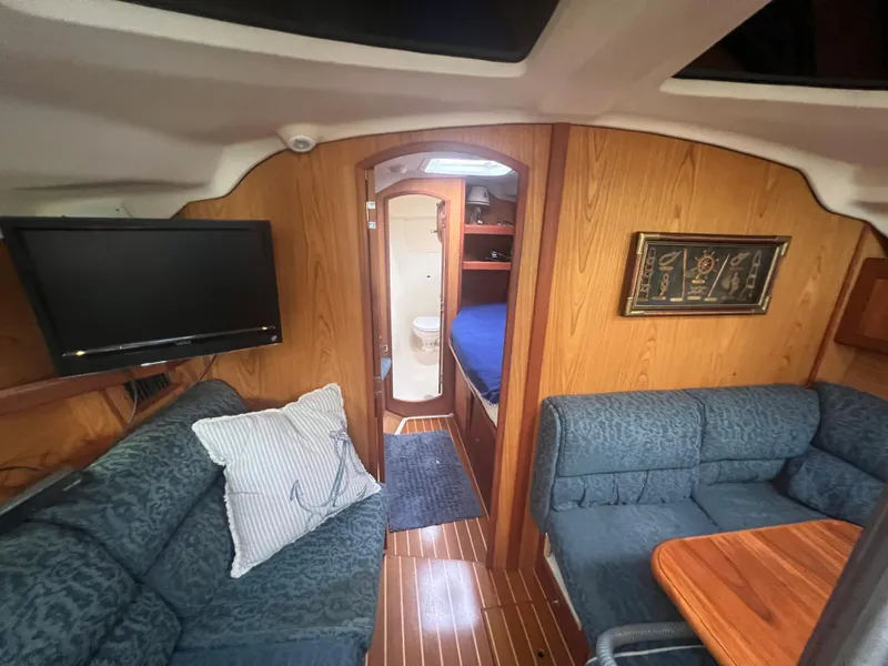 Slide: The Image of Interior of 2000 Hunter 410 yacht with cozy seating and modern amenities. - 31