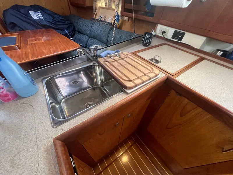 Slide: The Image of Interior of 2000 Hunter 410 sailboat kitchen with sink and wooden cabinetry. - 39