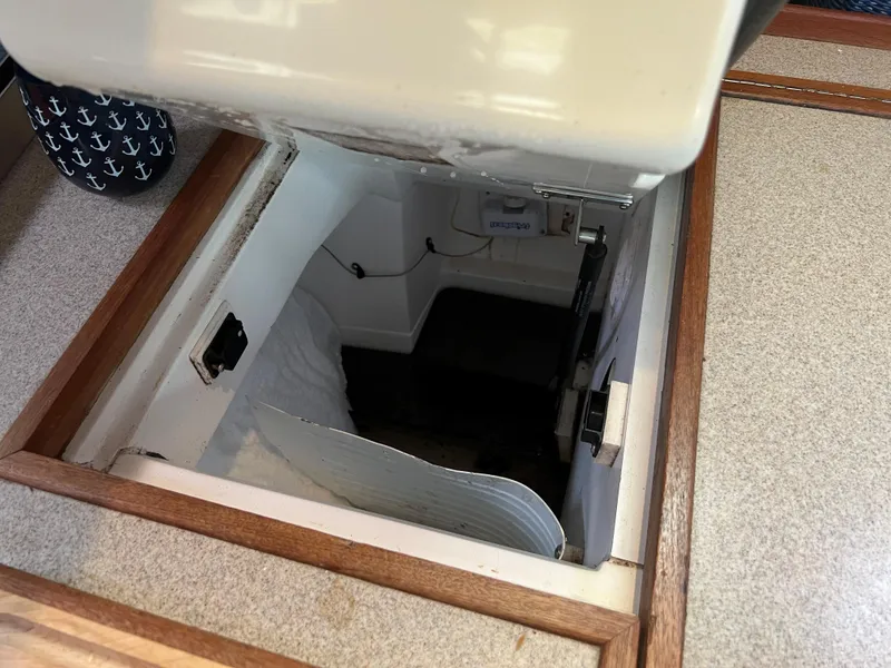 Slide: The Image of Hidden compartment in 2000 Hunter 410 sailboat, featuring a cozy interior space. - 40