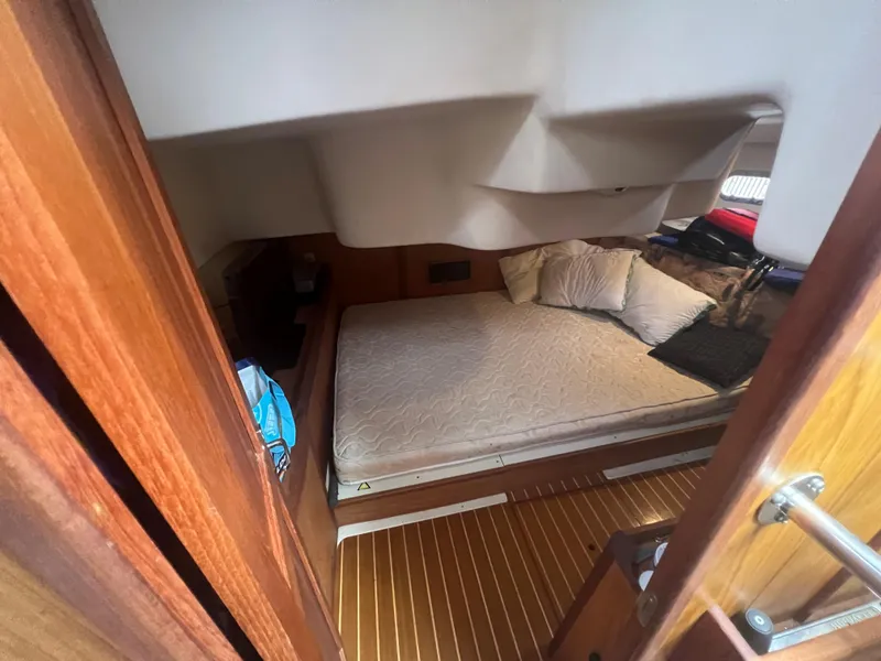 Slide: The Image of Cozy cabin interior of a 2000 Hunter 410 sailboat with a comfortable bed. - 42