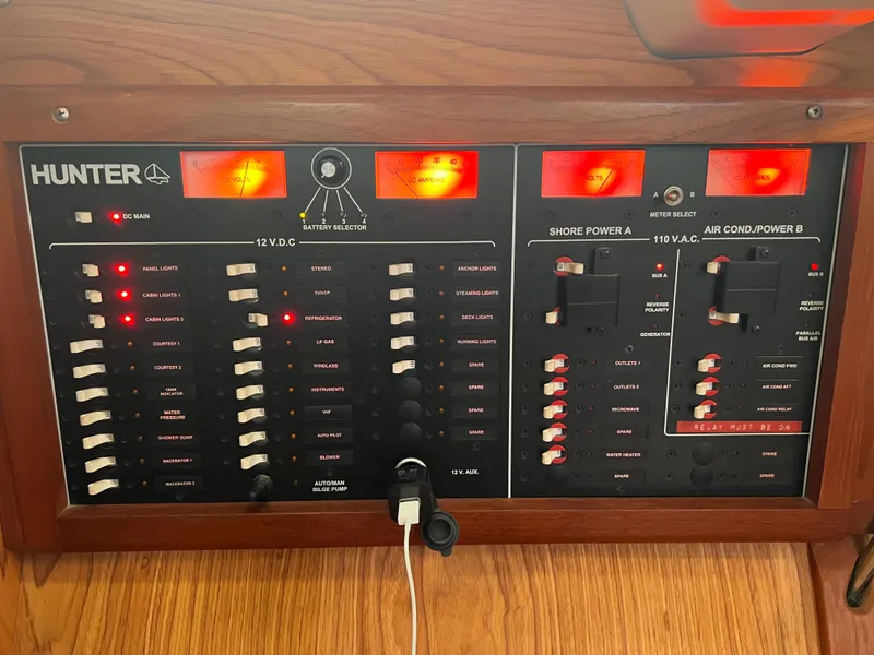 Slide: The Image of Electrical control panel of a 2000 Hunter 410 boat with switches and indicators. - 47