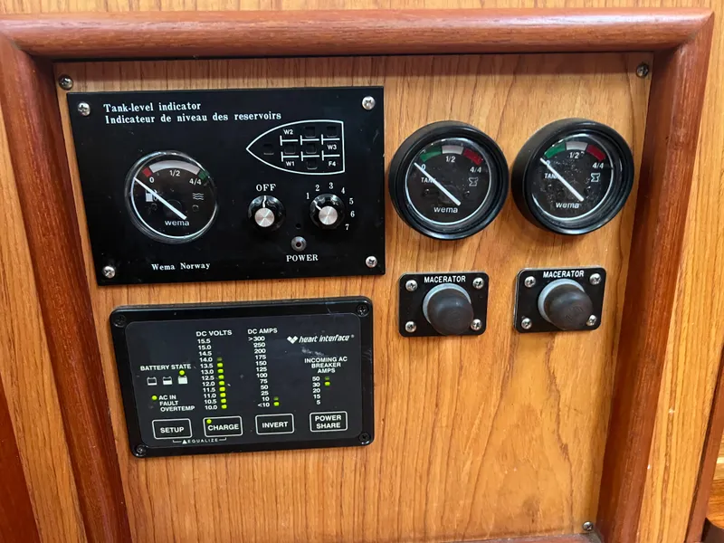 Slide: The Image of Control panel of a 2000 Hunter 410 boat with gauges and switches. - 48