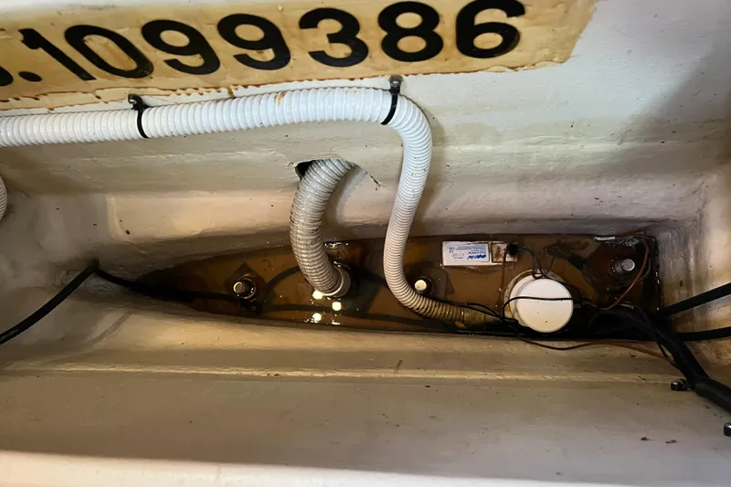 Slide: The Image of Bilge area of a 2000 Hunter 410 boat with hoses and wiring. - 49