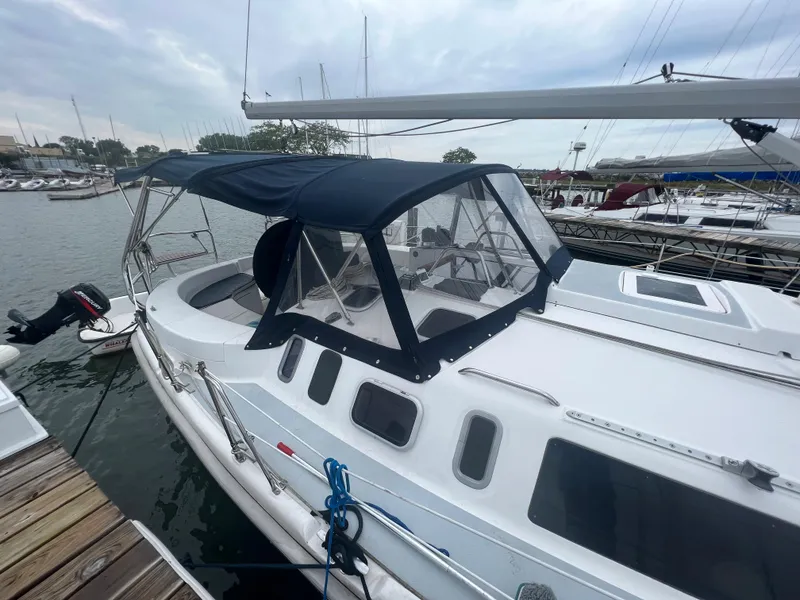 Slide: The Image of Sailboat docked at marina, Hunter 410 model, year 2000, with blue canopy. - 9