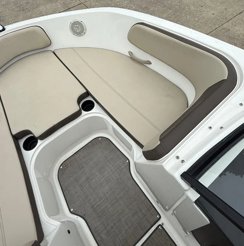 Slide: The Image of 2018 Bayliner VR6 Bowrider I/O interior with beige seating and gray flooring. - 14