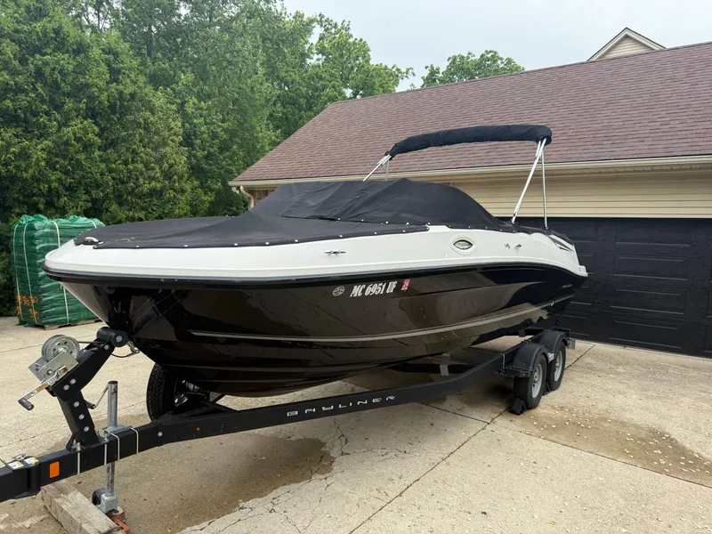 Slide: The Image of 2018 Bayliner VR6 Bowrider I/O boat on trailer, covered, parked in driveway. - 19