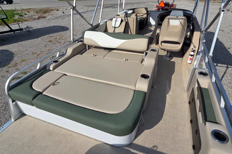 Slide: The Image of 2025 Avalon Platinum LSZ 2585 Versatile Rear Bench boat interior with beige and green seating. - 10