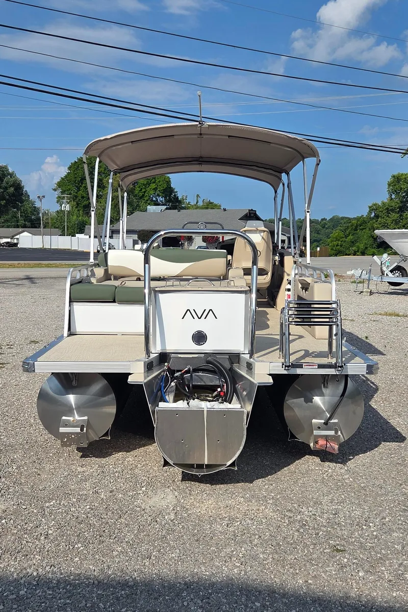 Slide: The Image of 2025 Avalon Platinum LSZ 2585 Versatile Rear Bench pontoon boat, parked outdoors under blue sky. - 3