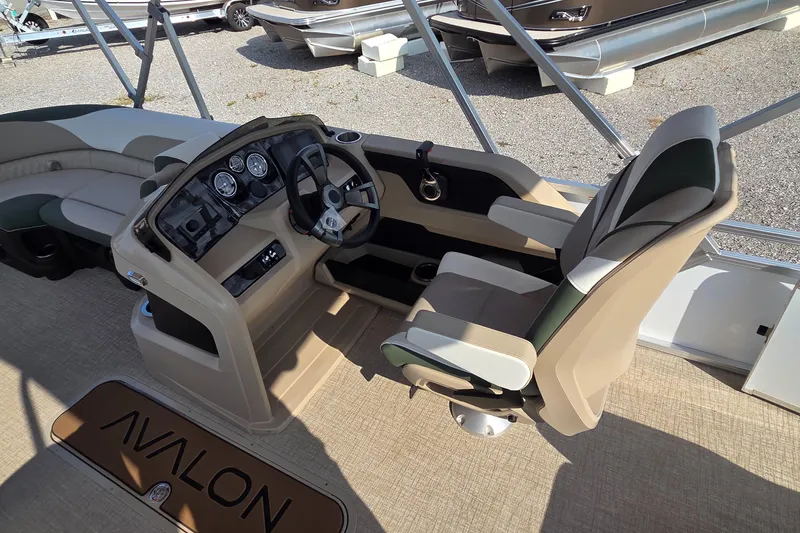 Slide: The Image of 2025 Avalon Platinum LSZ 2585 Versatile Rear Bench boat interior with helm and seating. - 6