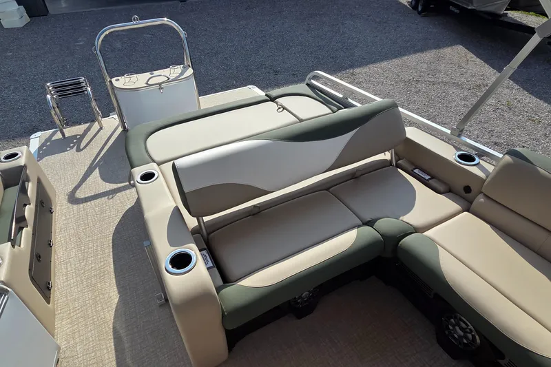 Slide: The Image of 2025 Avalon Platinum LSZ 2585 Versatile Rear Bench with beige and green seating, cup holders, and ladder. - 8