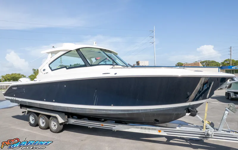 Slide: The Image of 2021 Pursuit DC 326 Dual Console boat on trailer, side view. - 12