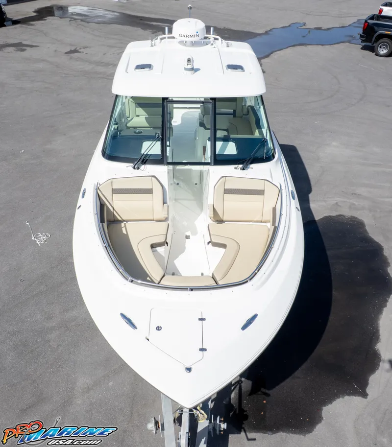 Slide: The Image of 2021 Pursuit DC 326 Dual Console boat, aerial view, docked on concrete surface. - 15