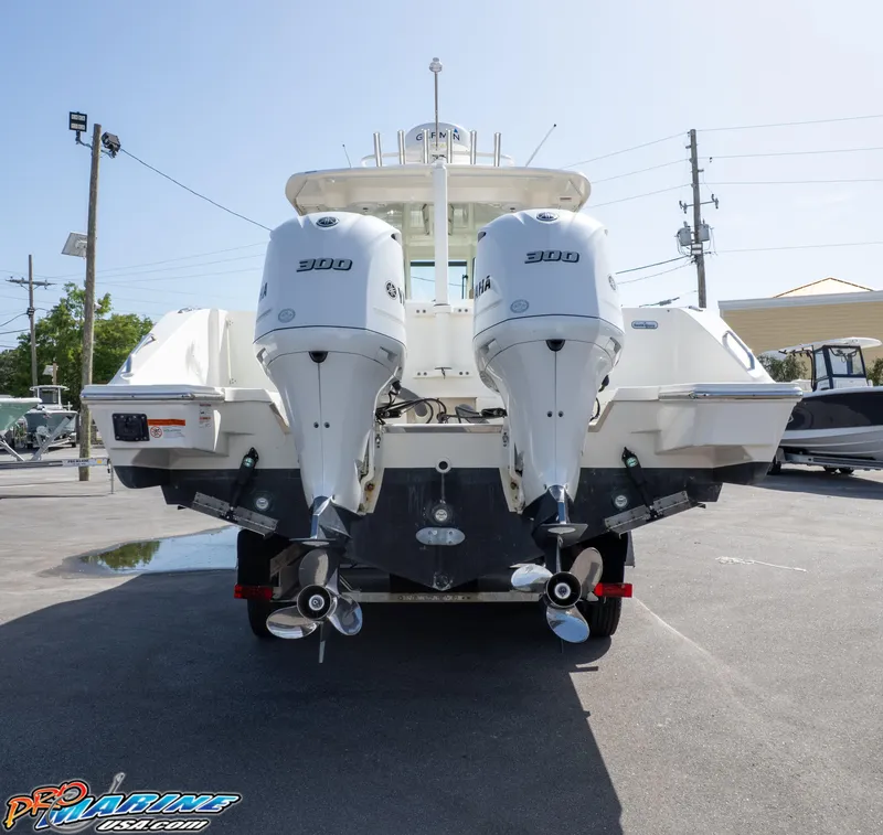 Slide: The Image of 2021 Pursuit DC 326 Dual Console boat with twin outboard engines, rear view. - 18