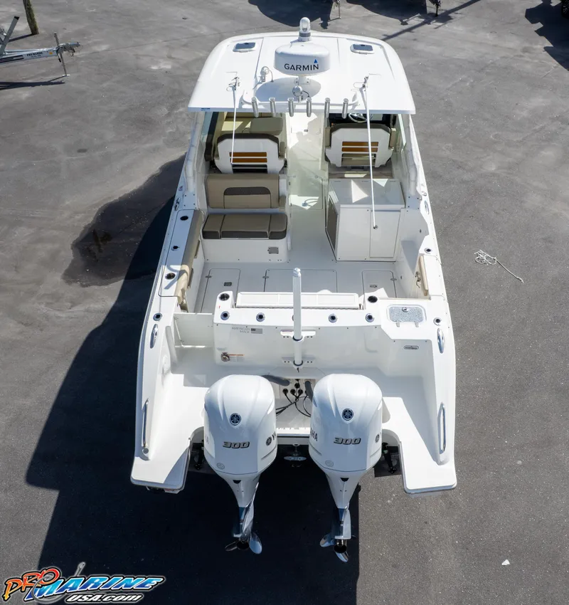 Slide: The Image of 2021 Pursuit DC 326 Dual Console boat with twin engines, aerial view. - 21