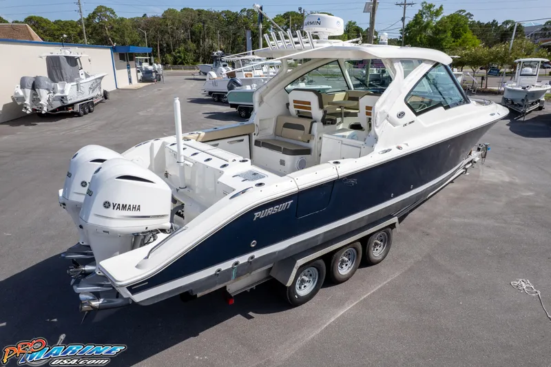 Slide: The Image of 2021 Pursuit DC 326 Dual Console boat with Yamaha engines on a trailer. - 22
