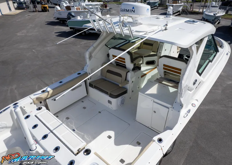 Slide: The Image of 2021 Pursuit DC 326 Dual Console boat with spacious seating and fishing rod holders. - 31