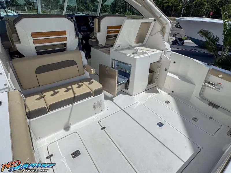 Slide: The Image of 2021 Pursuit DC 326 Dual Console boat interior with seating and storage compartments. - 34