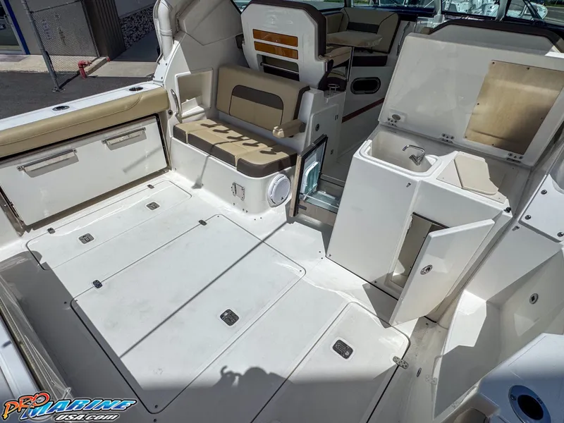 Slide: The Image of 2021 Pursuit DC 326 Dual Console boat interior with seating and storage compartments. - 35
