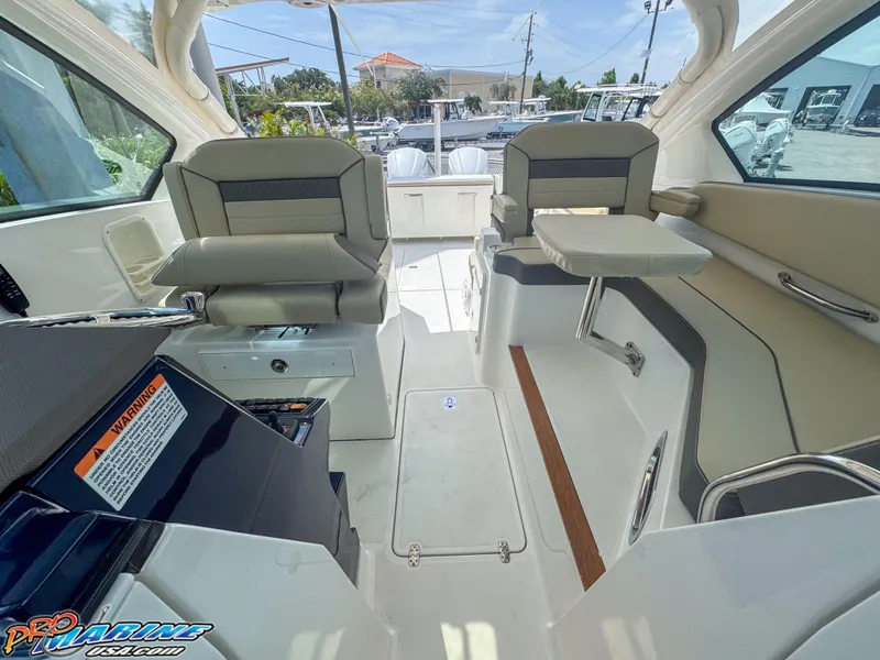 Slide: The Image of 2021 Pursuit DC 326 Dual Console interior with seating and table, showcasing modern design. - 38