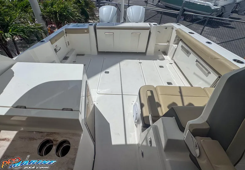 Slide: The Image of 2021 Pursuit DC 326 Dual Console boat interior with seating and storage compartments. - 39