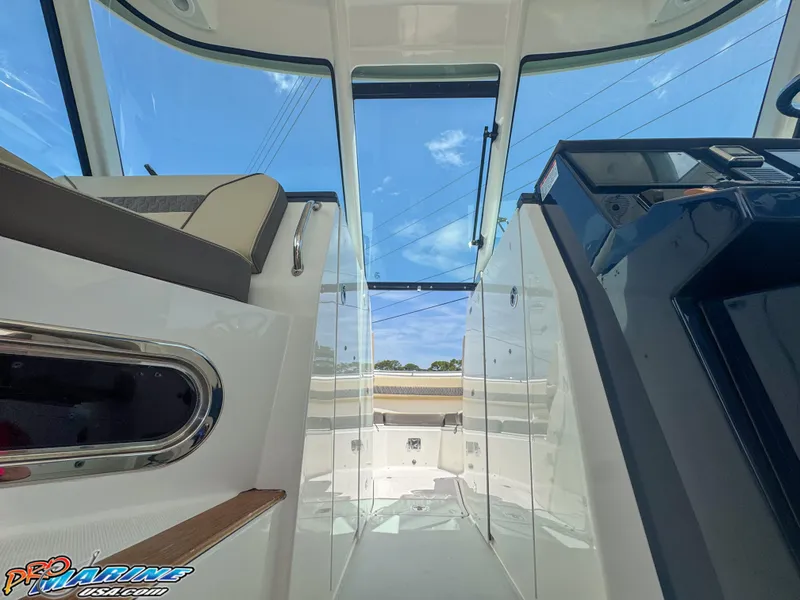 Slide: The Image of 2021 Pursuit DC 326 Dual Console interior with clear sky view through glass roof. - 40