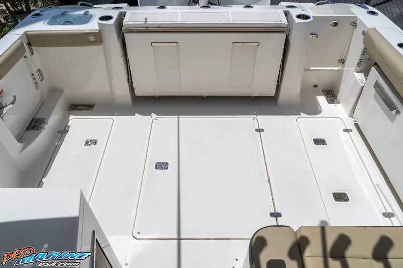 Slide: The Image of 2021 Pursuit DC 326 Dual Console boat deck, spacious layout, clean design, and storage compartments. - 43