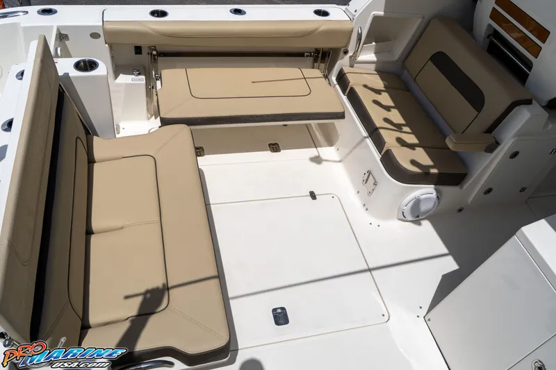 Slide: The Image of 2021 Pursuit DC 326 Dual Console boat interior with beige seating and spacious layout. - 49