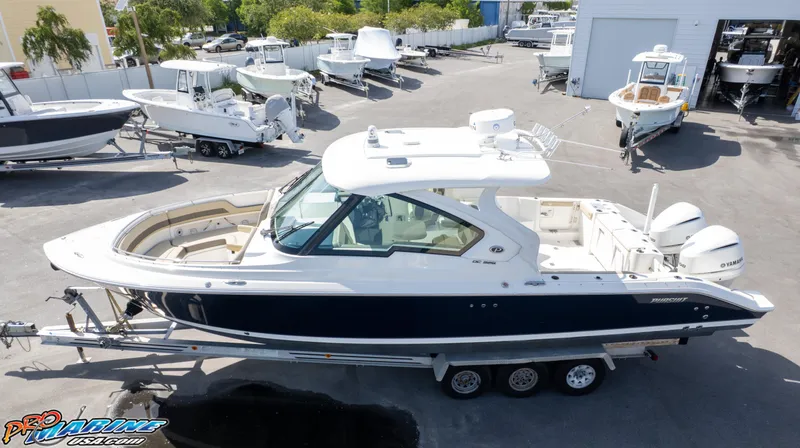 Slide: The Image of 2021 Pursuit DC 326 Dual Console boat on trailer in marina lot. - 5