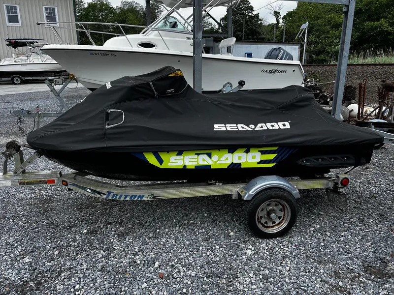 Slide: The Image of 2017 Sea-Doo Wake Pro 230 on trailer, covered, parked on gravel. - 10