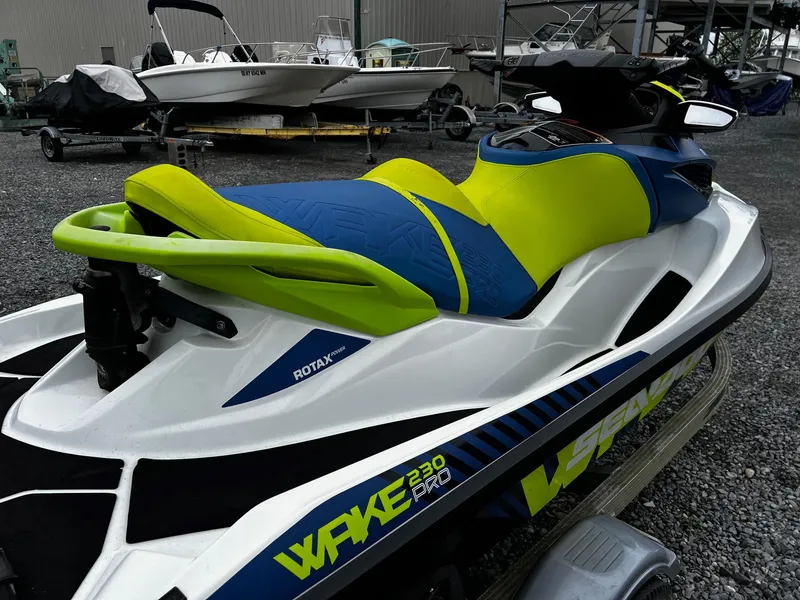 Slide: The Image of 2017 Sea-Doo Wake Pro 230 jet ski with vibrant blue and green seat design. - 3