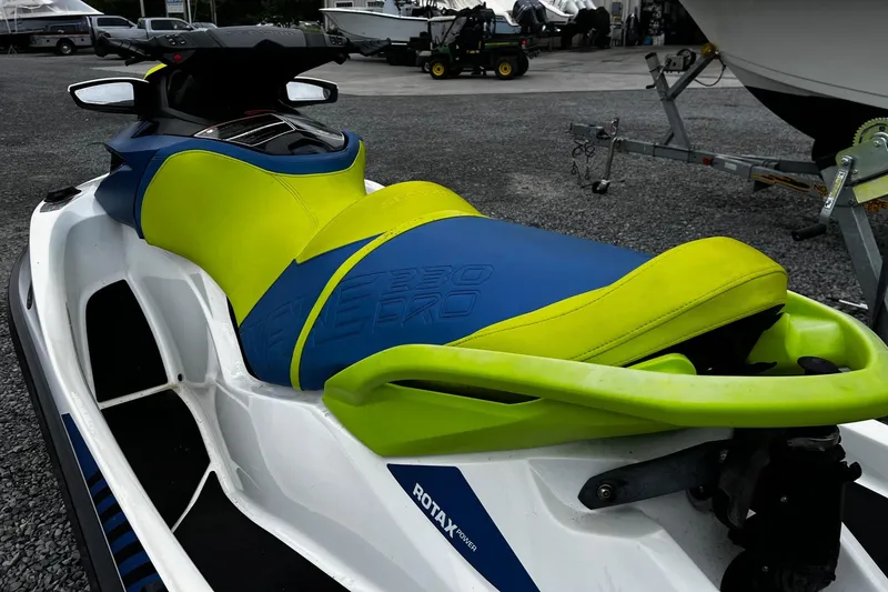 Slide: The Image of 2017 Sea-Doo Wake Pro 230 jet ski with vibrant blue and green seat design. - 4