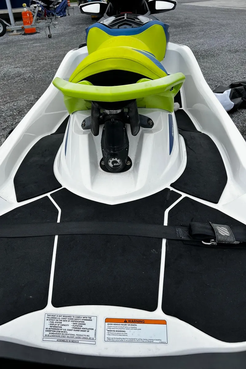 Slide: The Image of 2017 Sea-Doo Wake Pro 230 jet ski with vibrant green seat, docked on shore. - 8